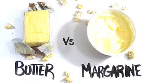 A block of butter next to a tub of margarine.