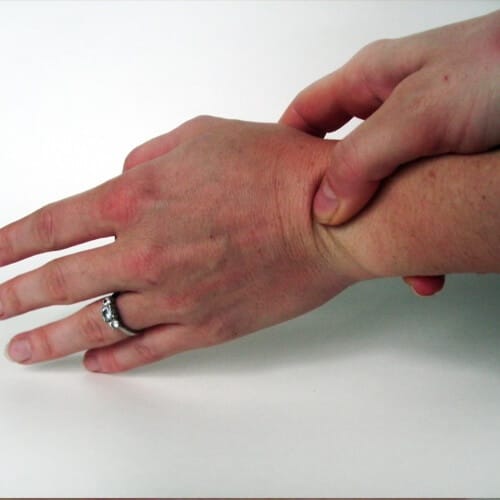 A person holding their wrist as if in great pain